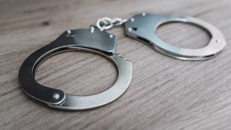 handcuffs on a wooden table. the concept of arrest and crime
