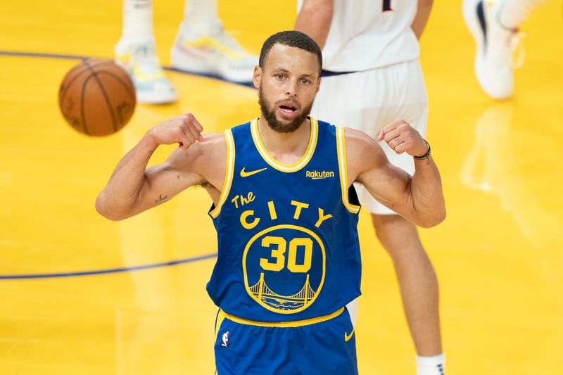 Steph Curry flexes during a Warriors game. 