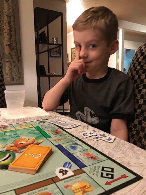 Joh's son paying Monopoly, Jr.