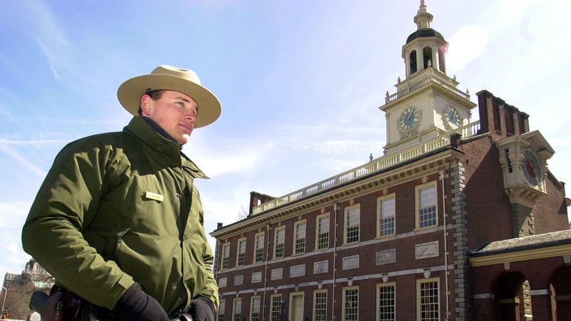 A national park ranger stands guard at Independence Hall.