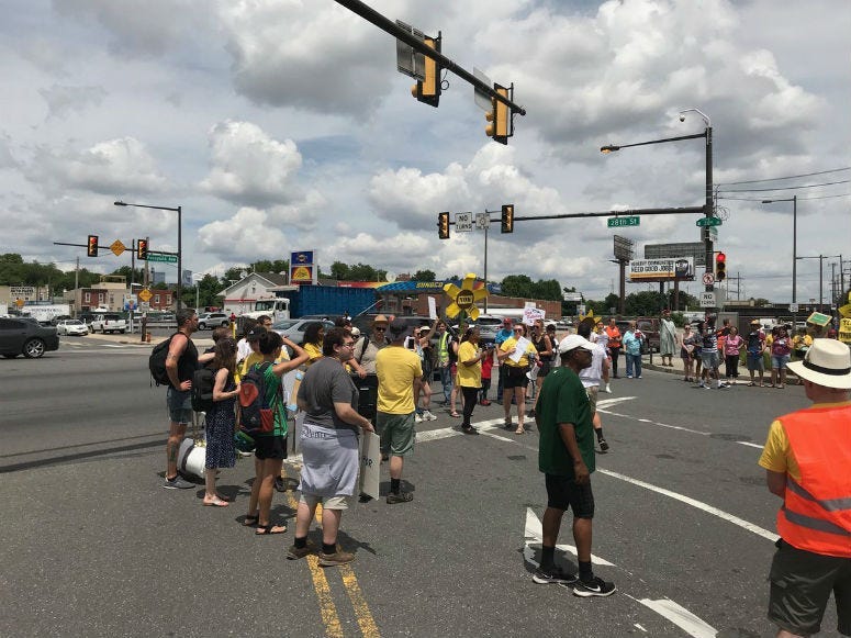 Sixteen police cars lined the street near 28th Street and Passyunk Avenue in South Philadelphia Tuesday afternoon as protesters, who say they want the Philadelphia Energy Solutions refinery shut down, blocked the intersection into the plant.