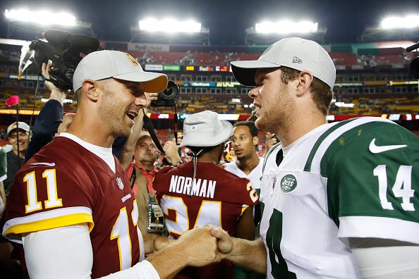 Sam Darnold fist bumps Alex Smith
