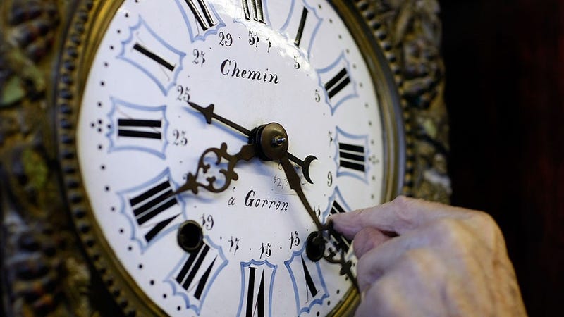 Howie Brown adjusts the time on a clock back one hour for the end of day light savings time at Brown's Old Time Clock Shop November 2, 2007 in Plantation, Florida. 