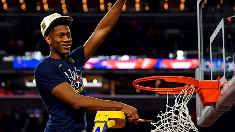 Virginia Cavaliers guard De'Andre Hunter (12) cuts down the net after beating the Texas Tech Red Raiders in the championship game of the 2019 men's Final Four at US Bank Stadium in Minneapolis.