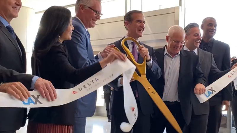 Los Angeles Mayor Eric Garcetti cutting the ribbon at Delta's unveiling of its new terminal facility at Los Angeles International Airport on March 28, 2022.