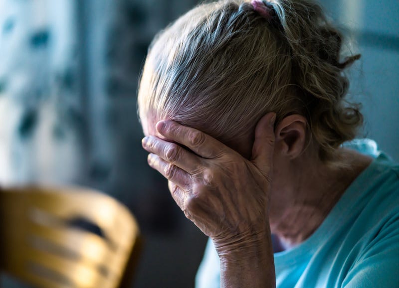 dementia illustration of senior holding her head in hand