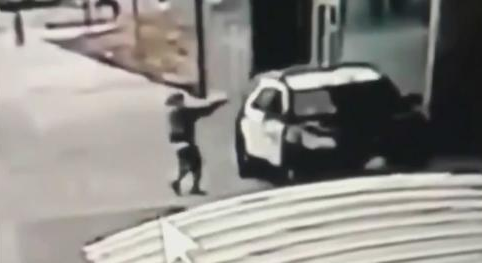 surveillance video of man aiming gun at sheriff's vehicle