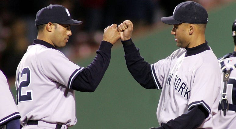 Derek Jeter and Mariano Rivera celebrate a win in Boston on April 13, 2005.