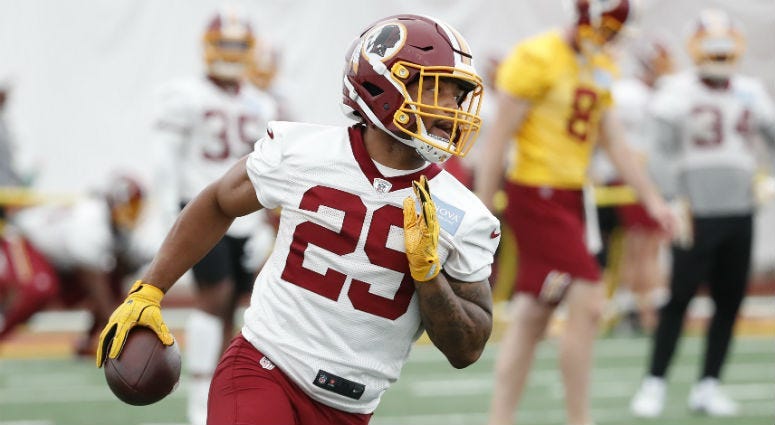 Redskins RB Derrius Guice carries the ball during a practice drill. 