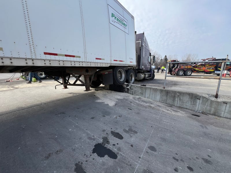Truck hits concrete abutment