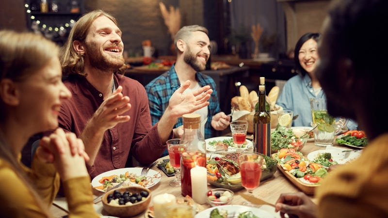 Two happy couples enjoying a meal in a restaurant