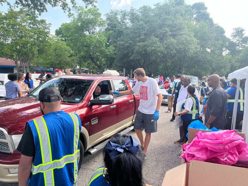 Mavericks' legend Dirk Nowitzki helps load cars with food at the Mark Cuban Heroes Basketball Center on Tuesday, May 7, 2024.