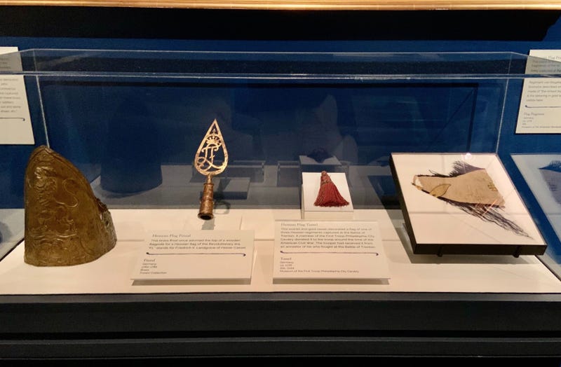Artifacts including a Hessian soldier's cap and piece of a silk flag are on display at the Museum of the American Revolution.