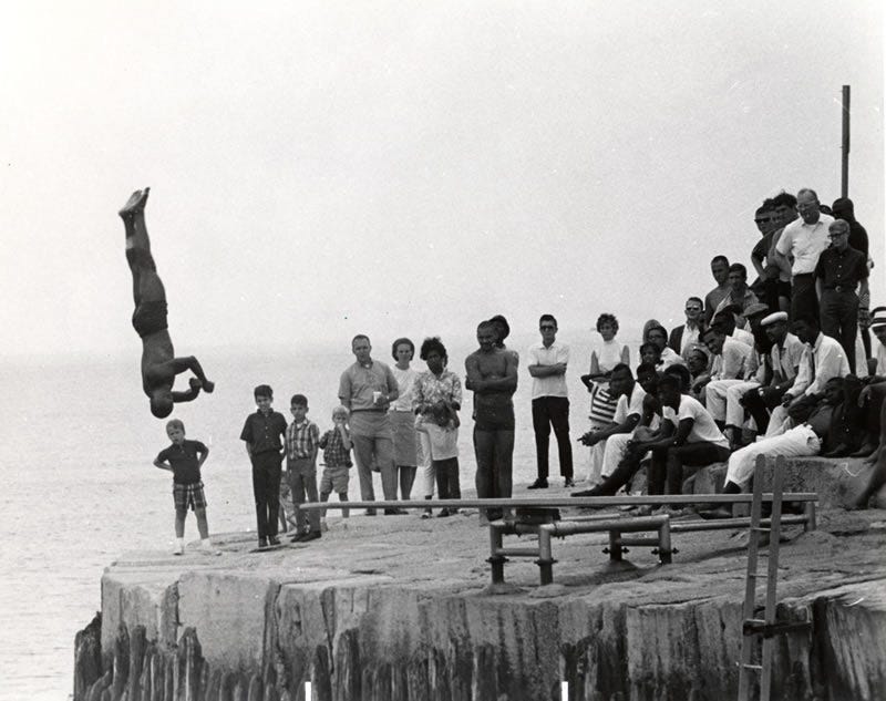 Earlier Chicago Air and Water Shows featured a diving competition. Here, a diver leaps off of a diving board into Lake Michigan.