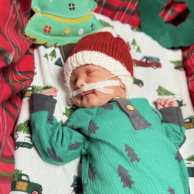 Baby in pine tree onesie