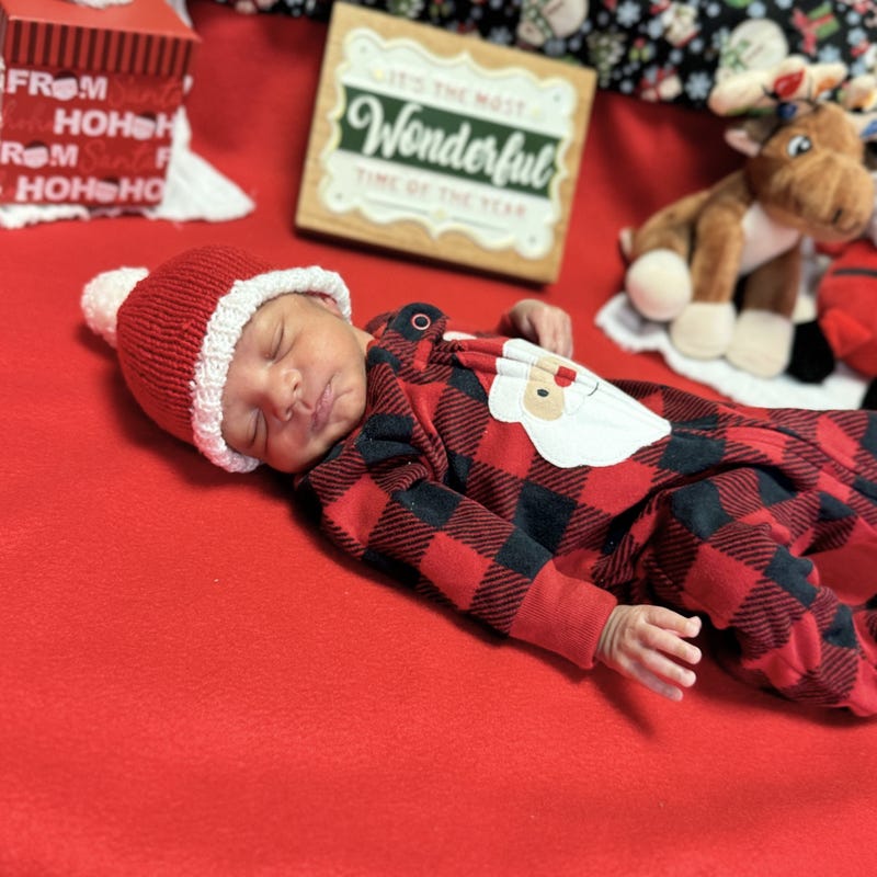 Sleeping baby in Santa plaid onesie