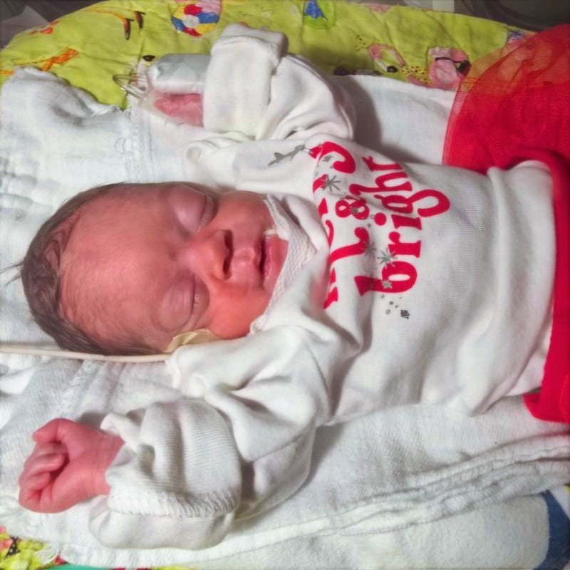 Baby with "Merry & Bright" onesie