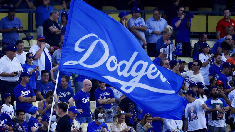 FILE - Fans cheer as the Los Angeles Dodgers flag is waved prior to Game One of the National League Championship Series between the Chicago Cubs and the Los Angeles Dodgers at Dodger Stadium on Oct. 14, 2017 in Los Angeles.