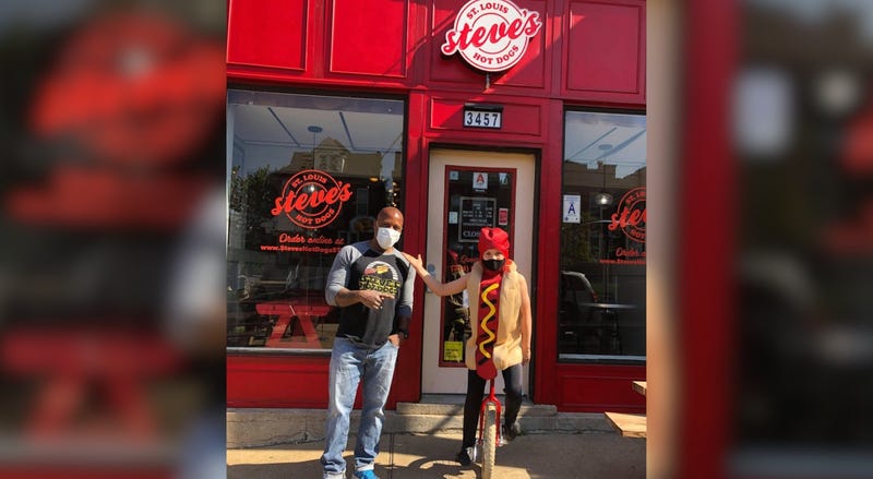 Steve Ewing of Steve's Hot Dogs poses with a hot dog