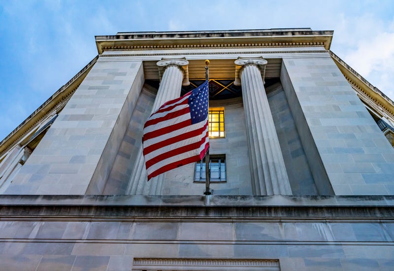 Flags fly at Justice Department building Pennsylvania Avenue Washington DC
