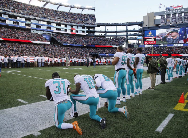 Dolphins players kneeling