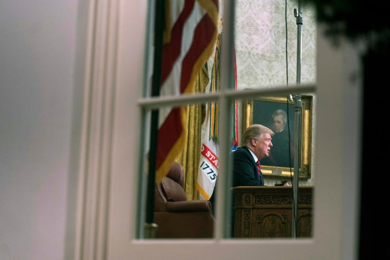 President Donald Trump is seen through the window of the Oval Office as he delivers a primetime address on the government shutdown 