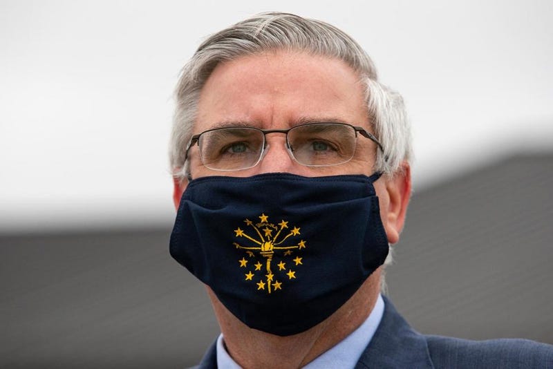 In this Thursday, April 30, 2020 file photo, Gov. Eric Holcomb wears a mask in Kokomo, Ind. Indiana will have a statewide face mask mandate starting next week, joining many other states in the attempt to slow the spread of the coronavirus.