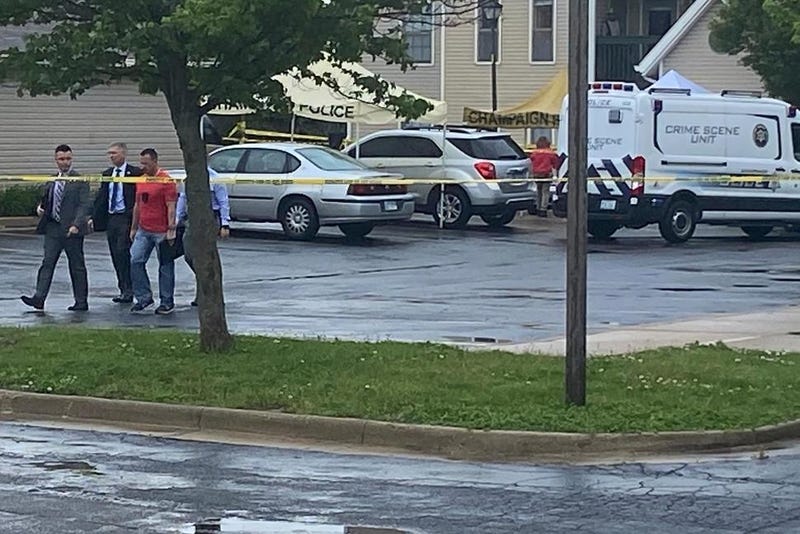 Police investigators work at the scene of a shooting in Champaign, Ill., Wednesday, May 19, 2021.
