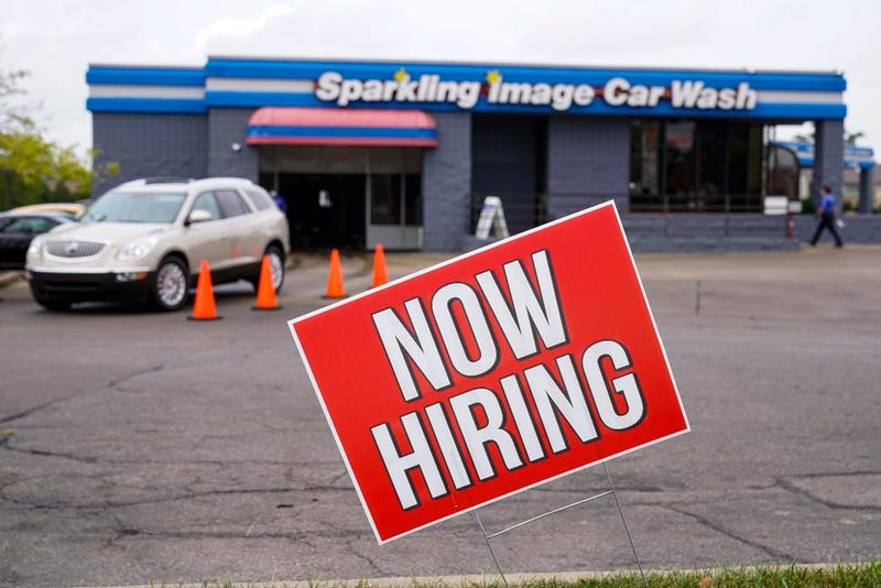 FILE - In this Sept. 2, 2020, file photo, a help wanted sign is displayed at a car wash in Indianapolis. Indiana’s Department of Workforce Development said Wednesday, July 7, 2021 that it still hasn’t decided how to continue payment of federal unemployment benefits more than a week after a judge ruled that the state must restart the extra $300 weekly payments to unemployed workers.