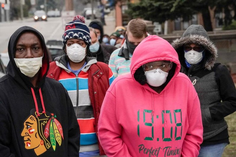 FILE - In this April 7, 2020 file photo, voters wearing masks as a precaution against the coronavirus, line up at Riverside High School for Wisconsin's primary election in Milwaukee. The Wisconsin Assembly plans to send the question of whether the state’s mask mandate should be repealed back to the state Senate, which voted last week to end the requirement. The Assembly delayed a vote last week amid concerns that repealing Democratic Gov. Tony Evers’ emergency order tied to the pandemic would result in Wisconsin losing about $50 million a month in federal money for poor people