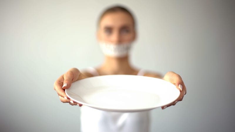 woman holding an empty plate