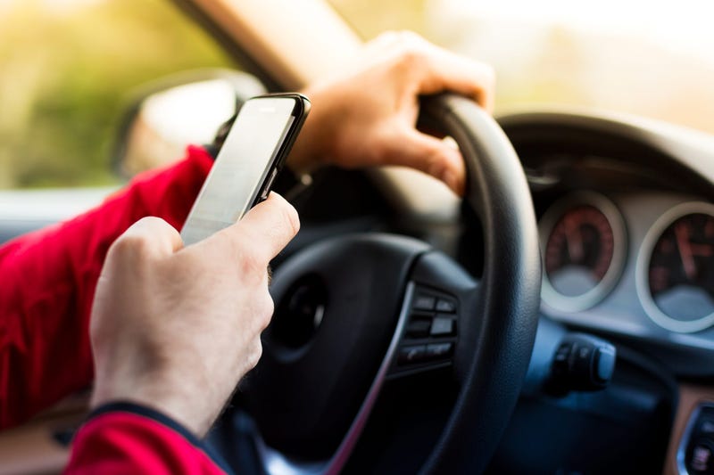 A person is texting while driving.