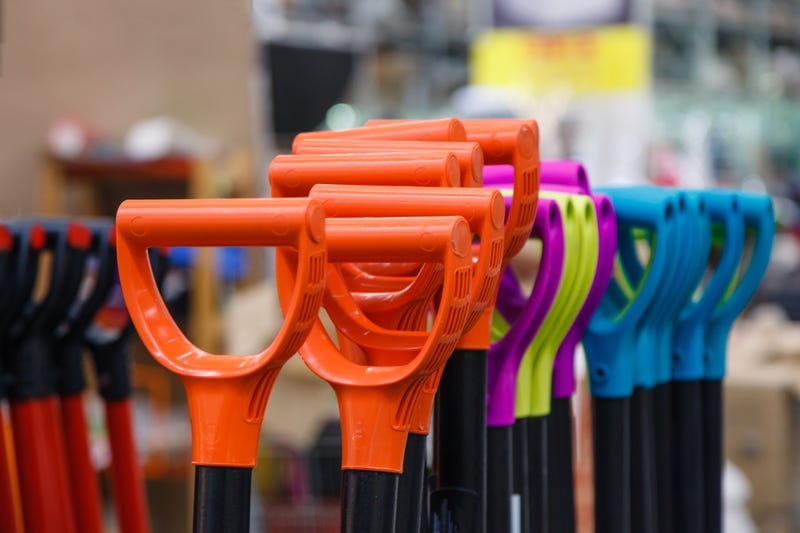 Colored plastic handle shovels in the store building tools. 