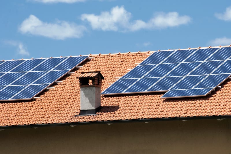 House roof with heat and power solar panels