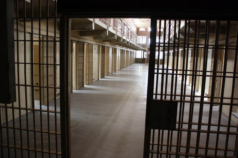 A multi-tiered cellblock is seen from the prison guard secured area. © Conchasdiver - Dreamstime.com
