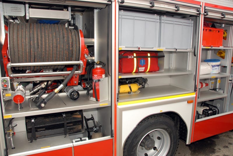 A photograph of a fire truck one sunny day