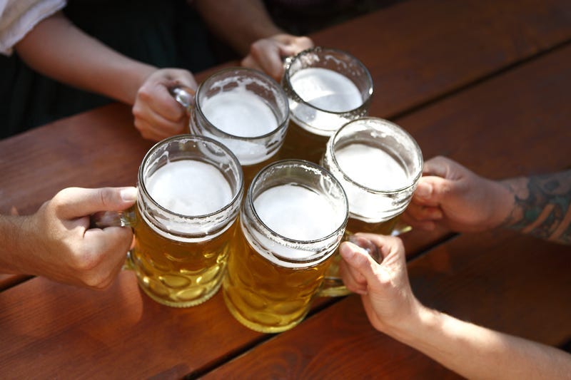 People in traditional costumes drinking beer in a Bavarian beer garden