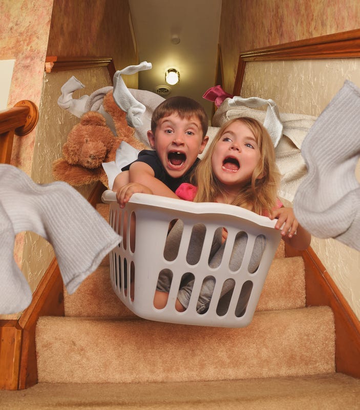 Kids sledding in laundry basket