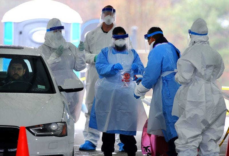 SHREWSBURY, MA - MARCH 19: Medical take a patient's coronavirus test during a trial run for a new FEMA drive-thru coronavirus testing clinic at CVS at 720 Boston Turnpike in Shrewsbury, MA on March 19, 2020. The clinic had a tent on Route 9 and was waitin