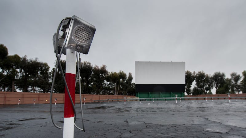 Drive in movie area with screen and speaker poles - stock photo