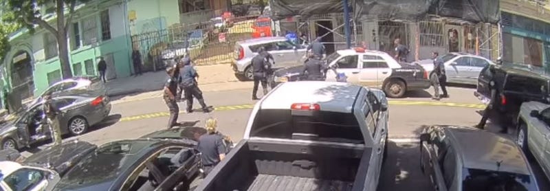San Francisco police officers swarm around a driver who had allegedly crashed a stolen car during a chase on May 29, 2019.