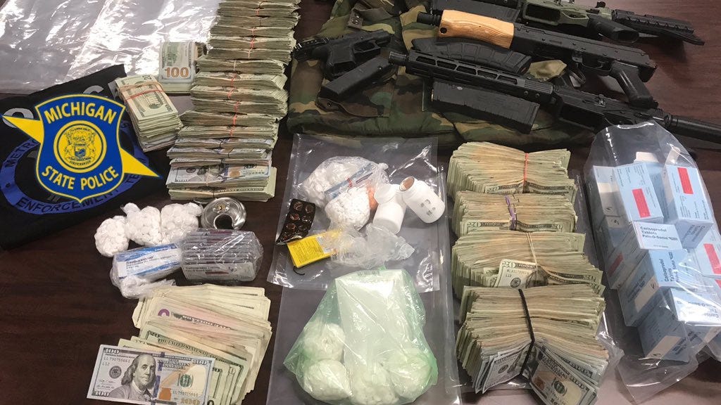 State Police: Guns, Armor, Pills, $99K In Cash Seized In Troy And Detroit Drug Raids