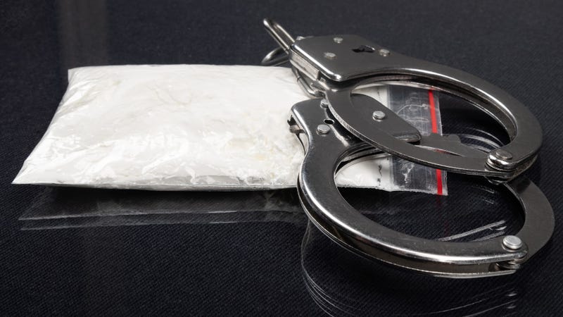 Drugs and handcuffs - stock photo