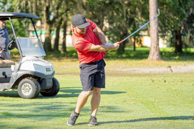 Pike hitting a golf ball
