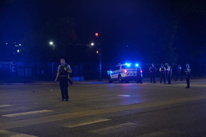 Chicago police gather at the intersection of Western Avenue and Fulton Street, where a police vehicle was rear-ended June 25, 2019.