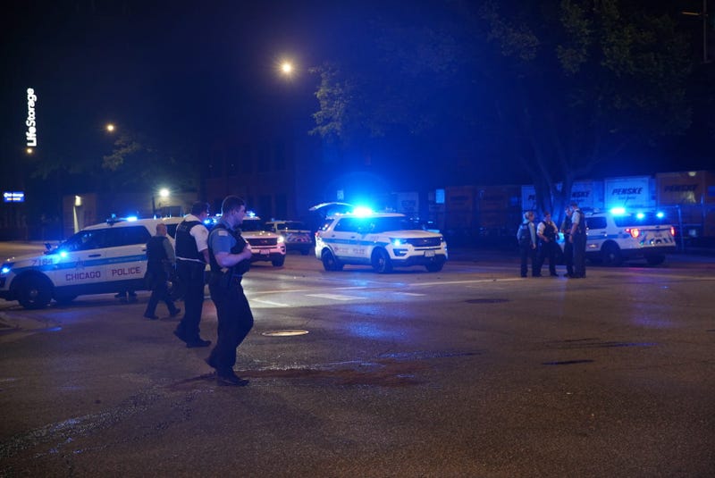 Chicago police gather at the intersection of Western Avenue and Fulton Street, where a police vehicle was rear-ended June 25, 2019.