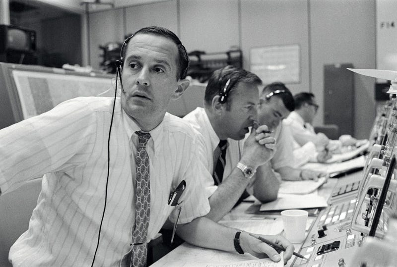 CAPCOM Charles Duke, with backup crewmen Jim Lovell and Fred Haise listening in during Apollo 11's descent