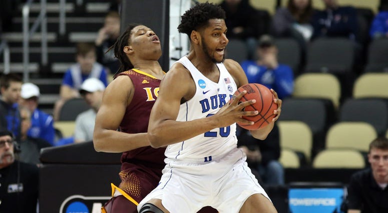 Duke center Marques Bolden in action against Iona forward Tyrell Williams during the first round of the NCAA tournament on March 15, 2018, at PPG Paints Arena.