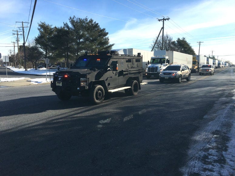 A SWAT vehicle arrives on the scene of a UPS facility in Logan Township following reports of an active shooter.