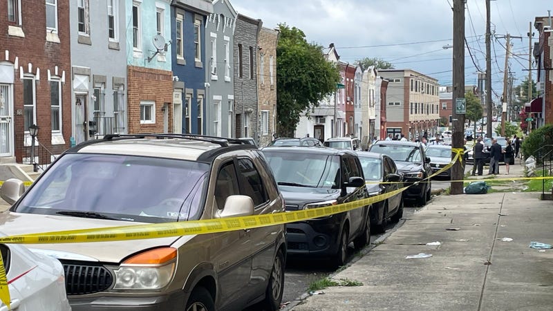 Caution tape lines the area where an FBI agent on Friday shot a man while agents were serving arrest and search warrants to someone at a nearby residence.